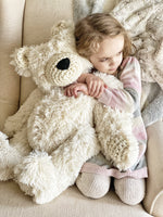 ClaraLoo large plush bear with white faux fur. This bear has white fur with cream colored crocheted ears, muzzle, hands, and feet. This handmade polar bear has a black nose.